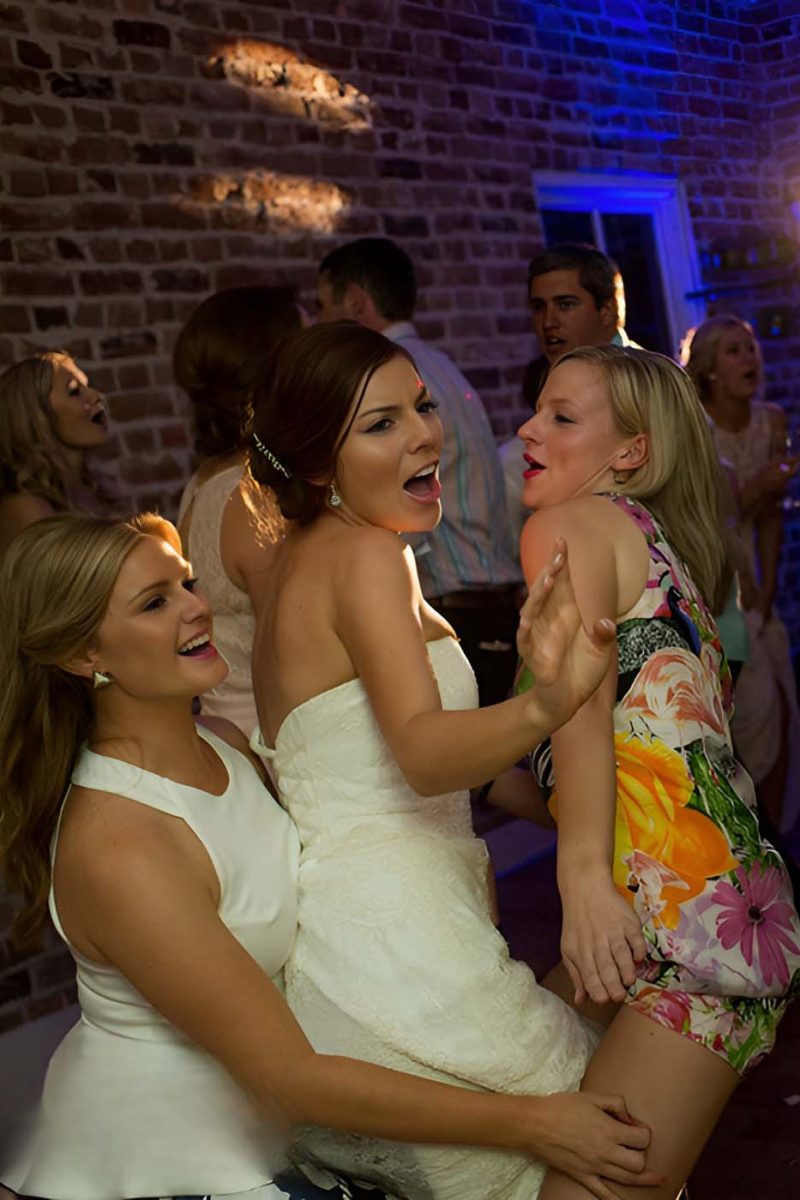 Bride and guests dancing during wedding reception